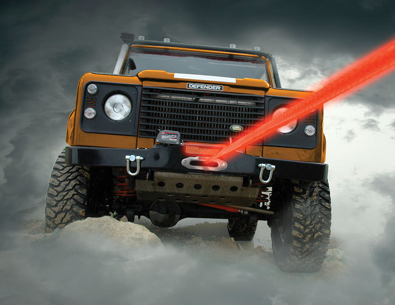 Land Rover with bright red winch rope coming through clouds